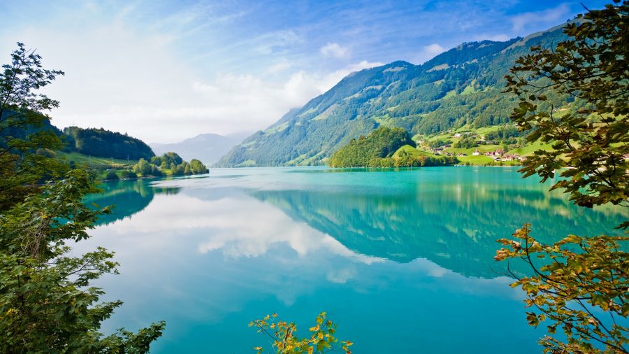 lake-mountains-trees-village-blue-sky-white-clouds_